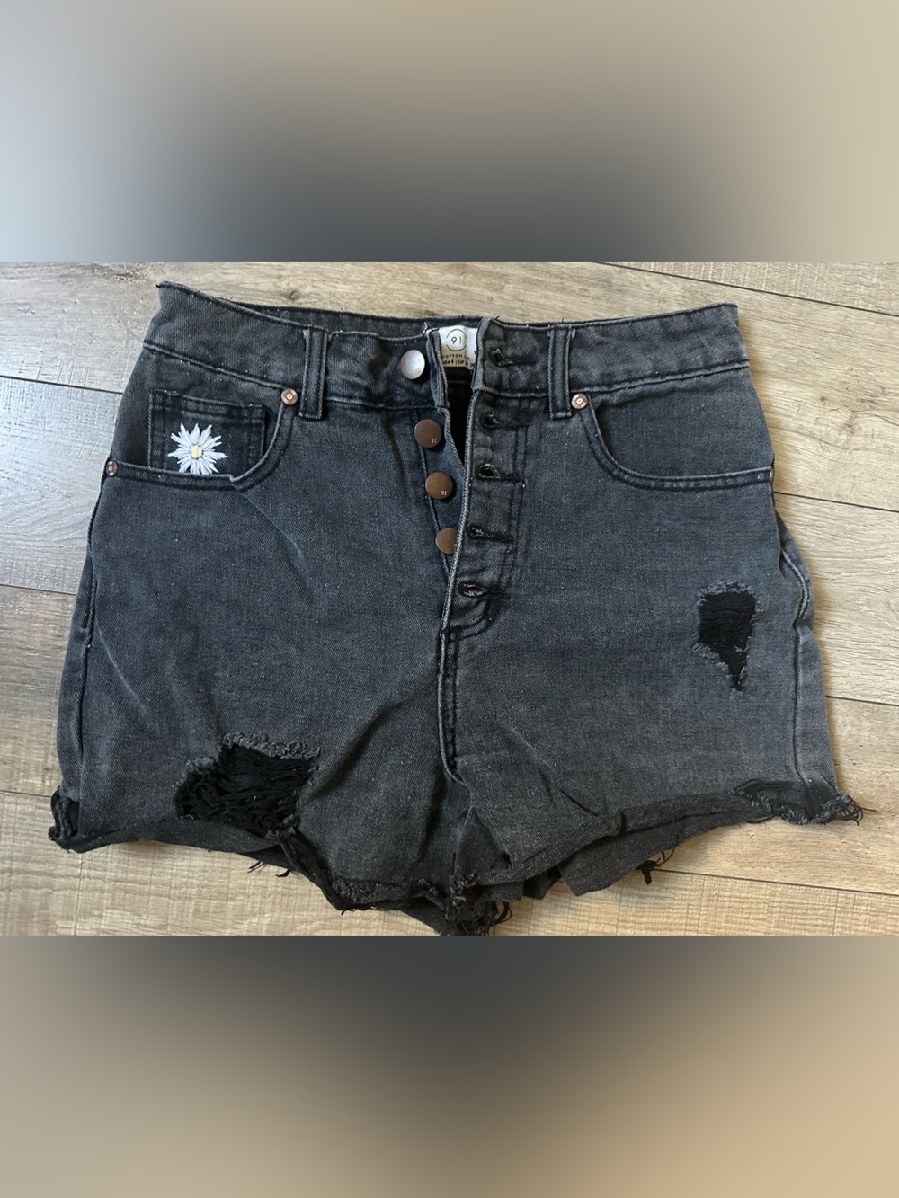 High-Rise Black Distressed Denim Shorts with Daisy Accent